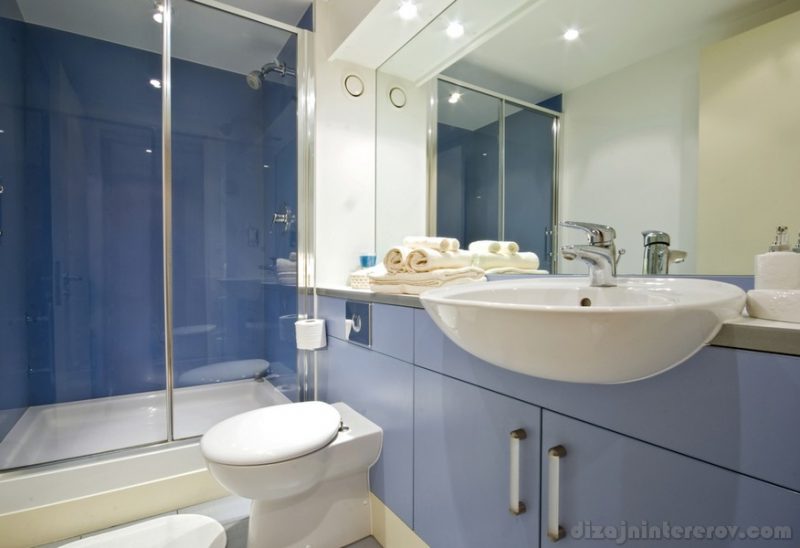 modern blue bathroom with shower cabin
