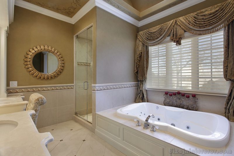 Master bath in elegant home with large tub