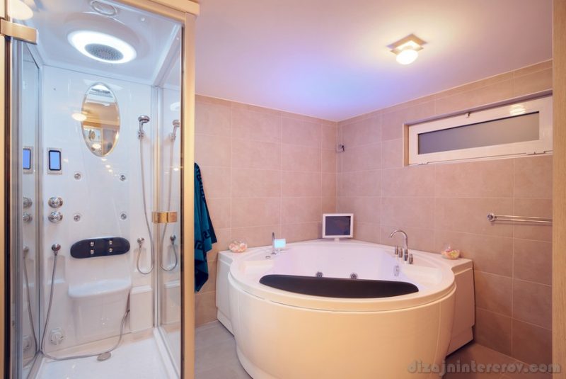 Interior of a modern bathroom, details of jacuzzi and bathtub.