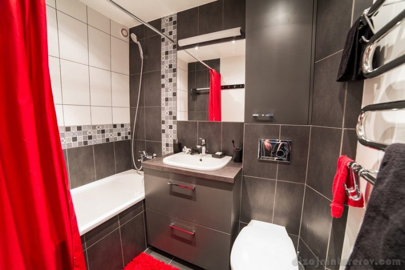 Inside of a modern bathroom ornamented with red colours