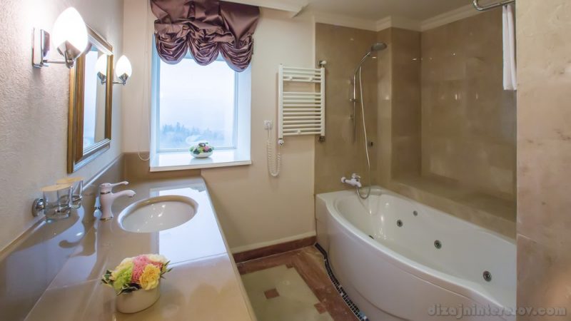 luxury bathroom interior complete with granite and beautiful tiled floors and walls.