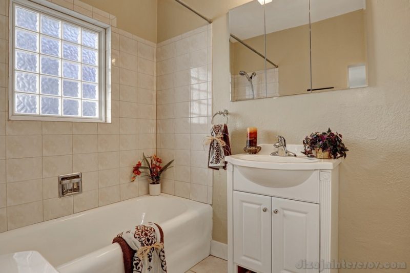 Clean and warm bathroom interior in soft beige and white tones. Northwest, USA